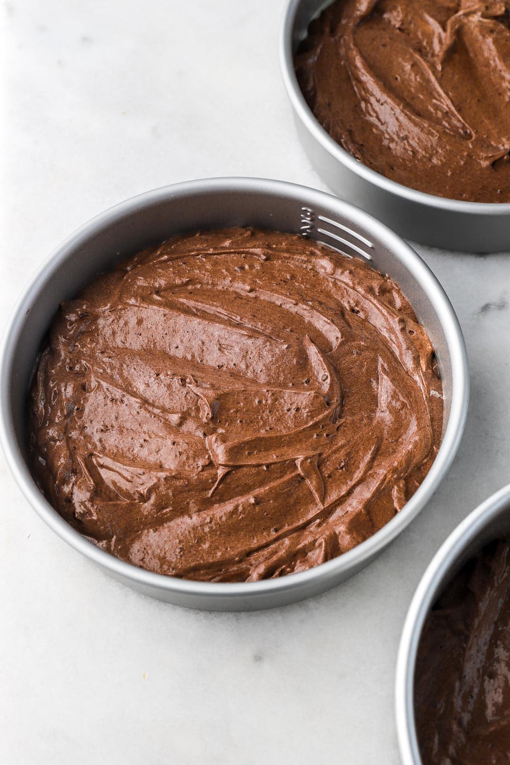 cake batter filling pans halfway 