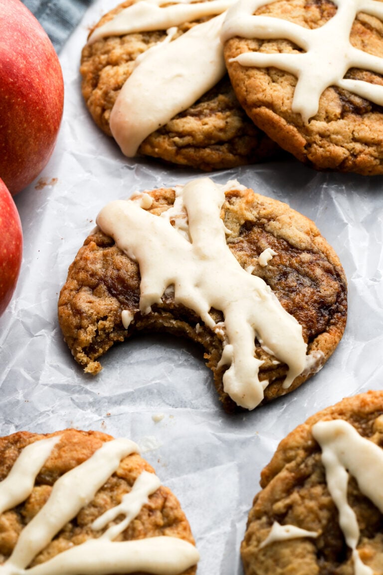 bitten apple butter cookie next to apples and other cookies