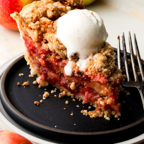 slice of apple cranberry pie with ice cream on top