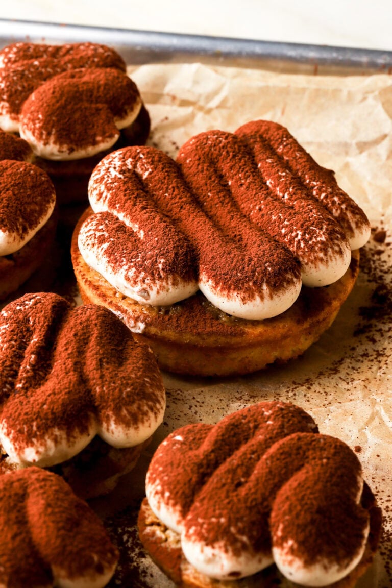 espresso soaked tiramisu donuts frosted with mascarpone cream and dusted with cocoa powder