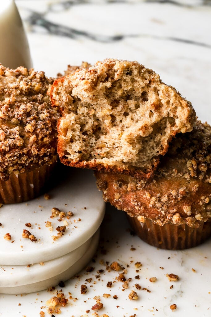 banana nut muffins ripped in half, pecan crumbs around it