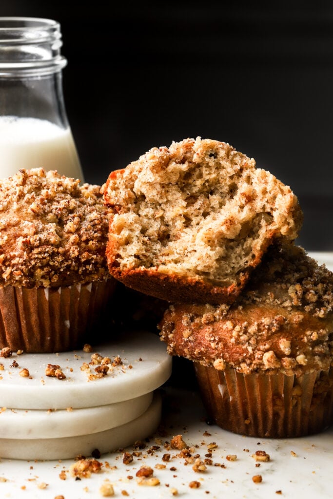 banana nut muffins with coasters and glass of milk