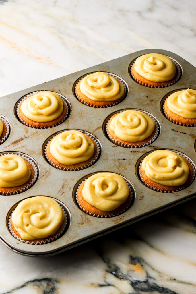 pastry cream piped onto cupcakes