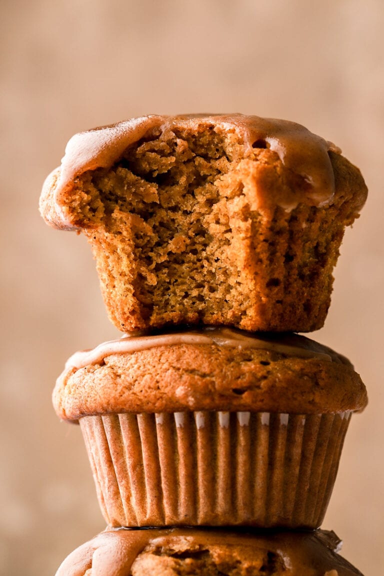 Pumpkin banana muffins stacked with bite taken out