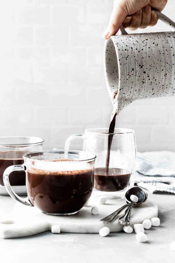 hot cocoa pouring in cup