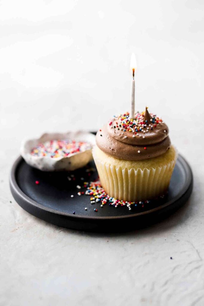 birthday cake cupcakes with candle and sprinkles