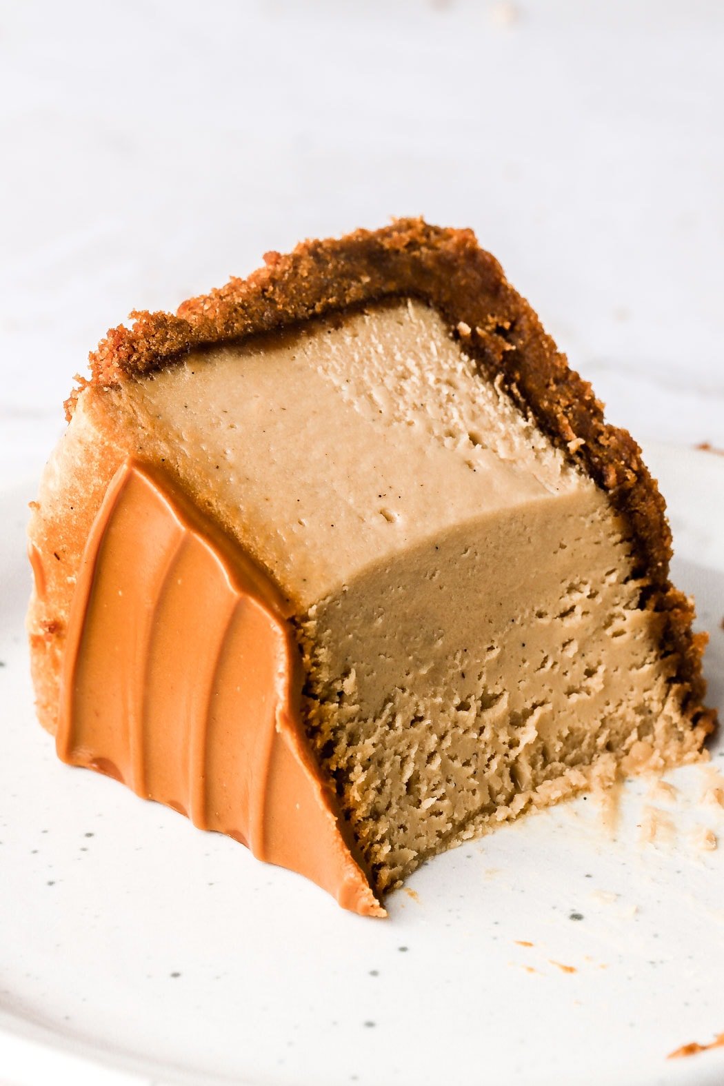 slice of cheesecake on it's side with a bite taken out