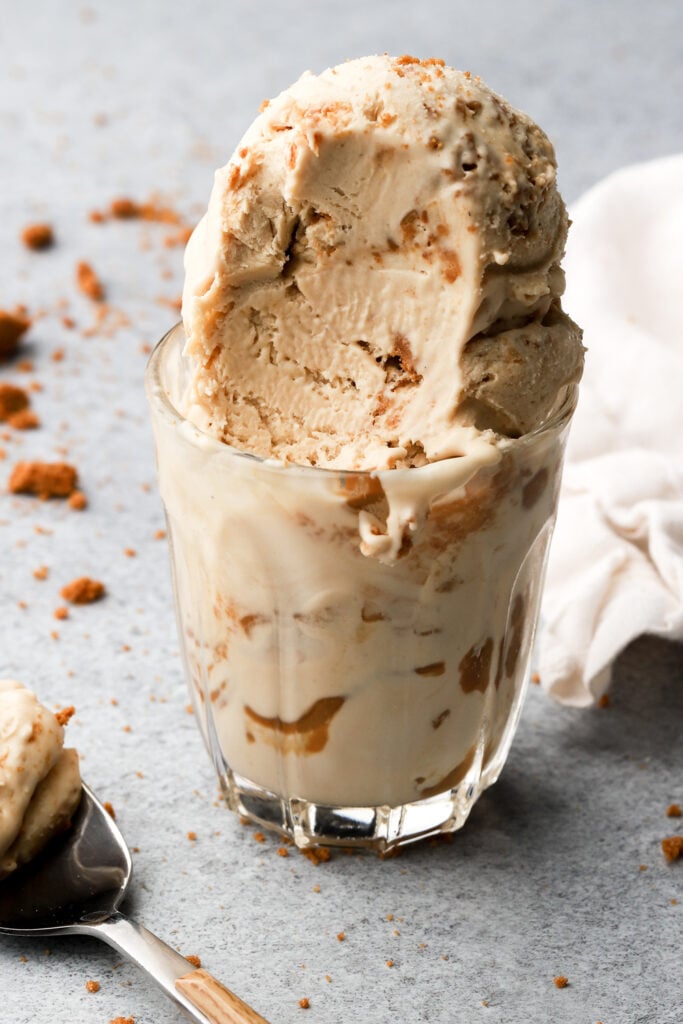 biscoff ice cream in a cup with a bite taken out