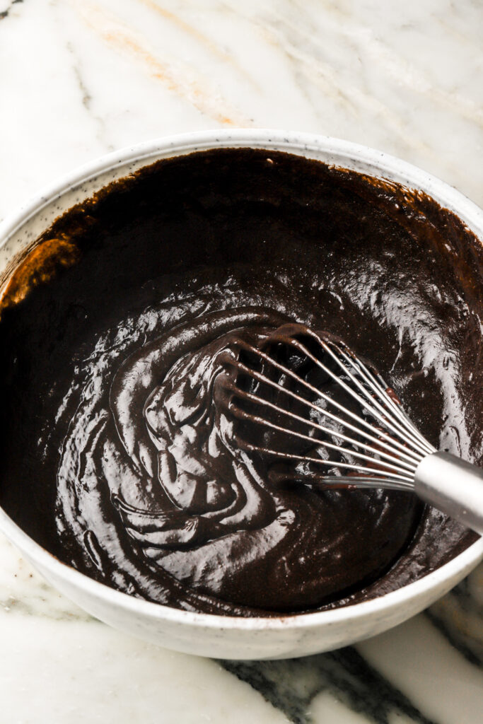 black cocoa powder, cream of tartar, vanilla and melted chocolate mixture whisked into the eggs and sugar