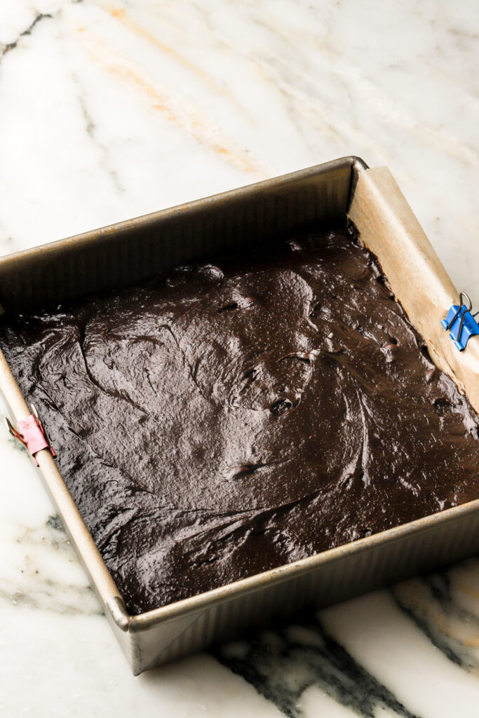 finished brownie batter in prepared pan