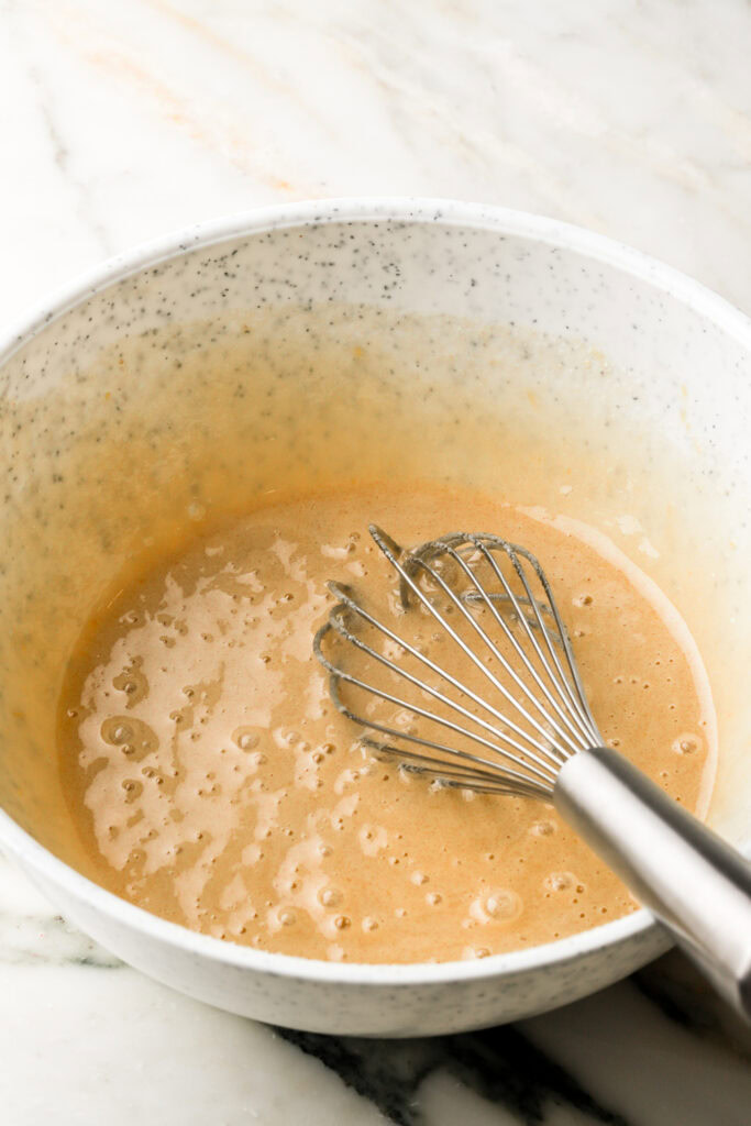 eggs and sugar whisked together in a bowl
