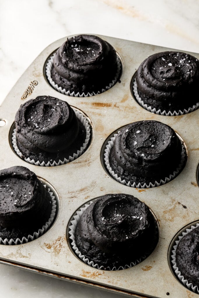 black cocoa frosting piped onto black cocoa cupcakes