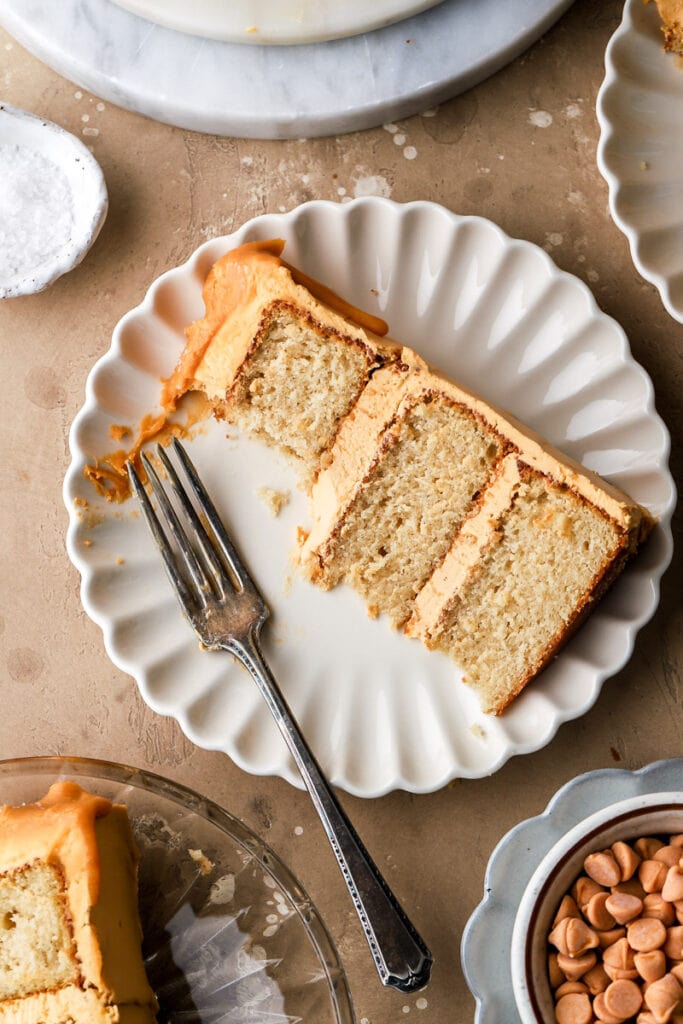 slice of butterscotch cake on a plate with a bite taken out