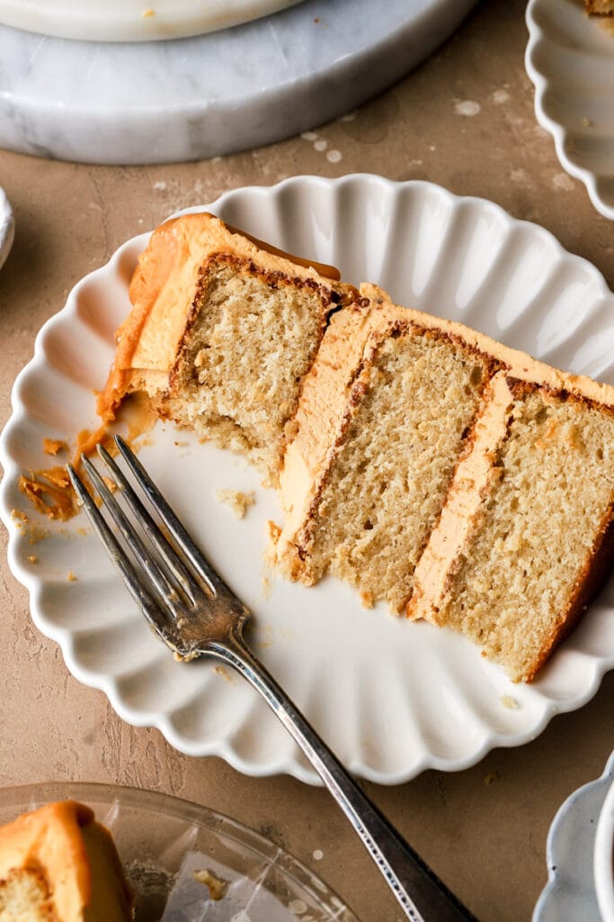 slice of cake on a plate with a bite taken out