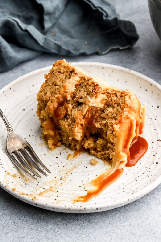 slice of caramel apple cake on a plate and bitten out of
