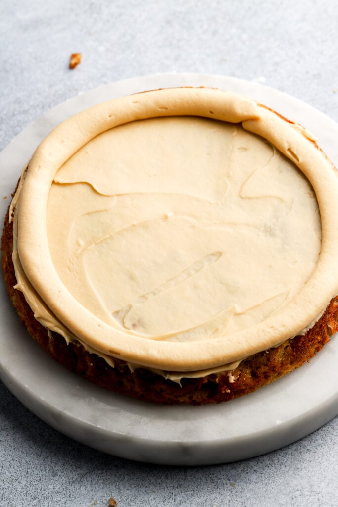 layer of cream cheese frosting and a border of cream cheese frosting