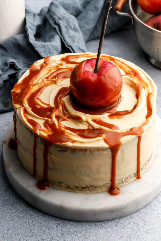 cake covered in salted caramel sauce with an apple on top