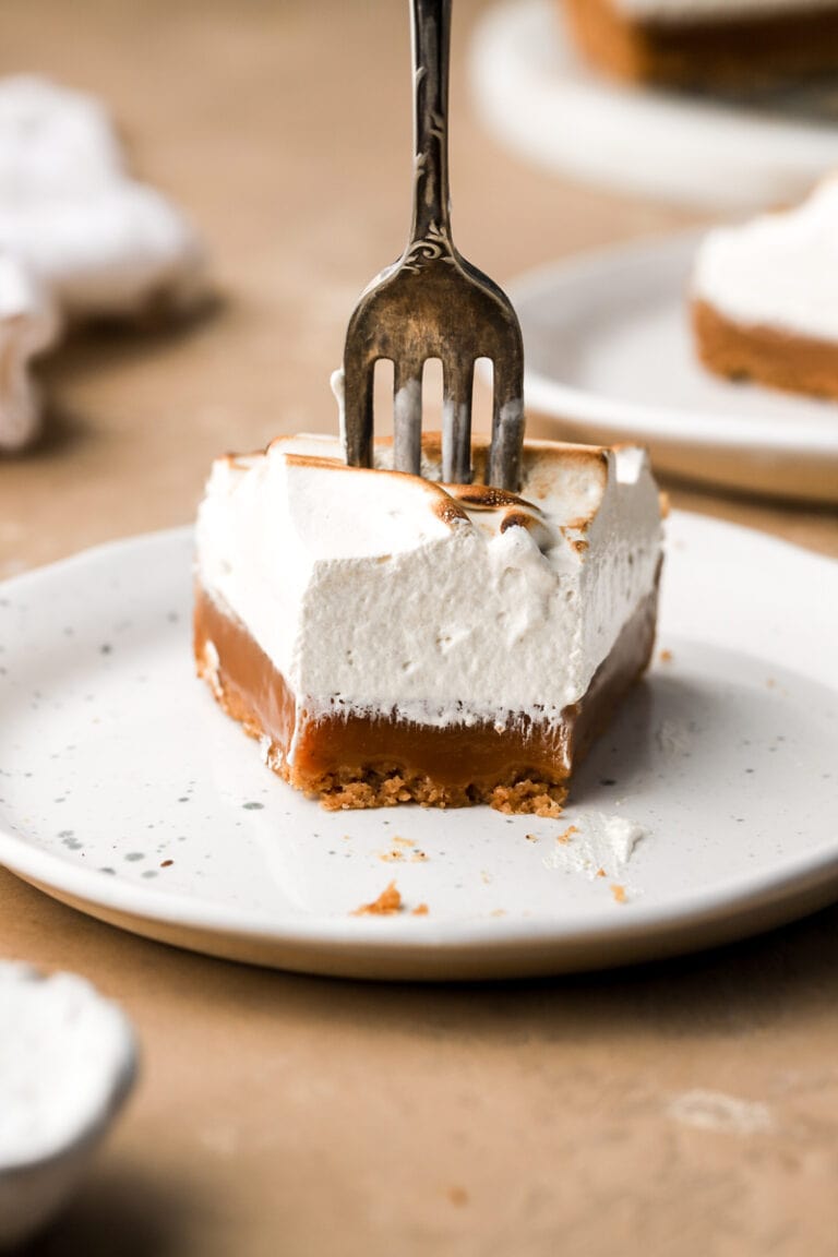 slice of caramel tart with the fork going through