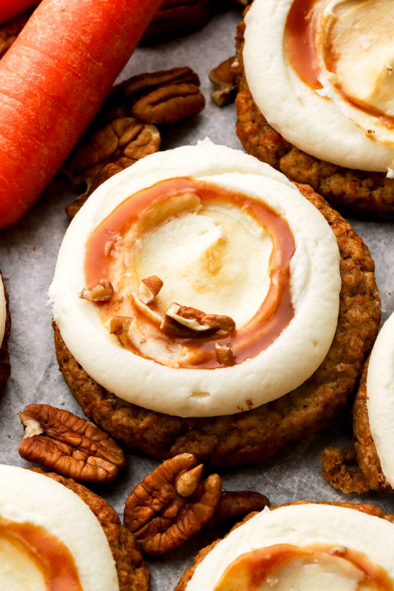 carrot cake cookies frosted with cream cheese frosting and salted caramel sauce