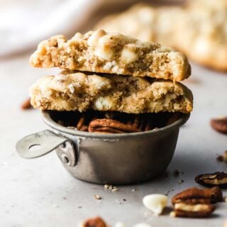 white chocolate chip cookies halves on top of pecans