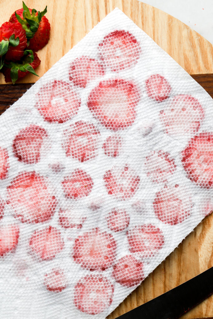 strawberries sliced drying on a paper towel
