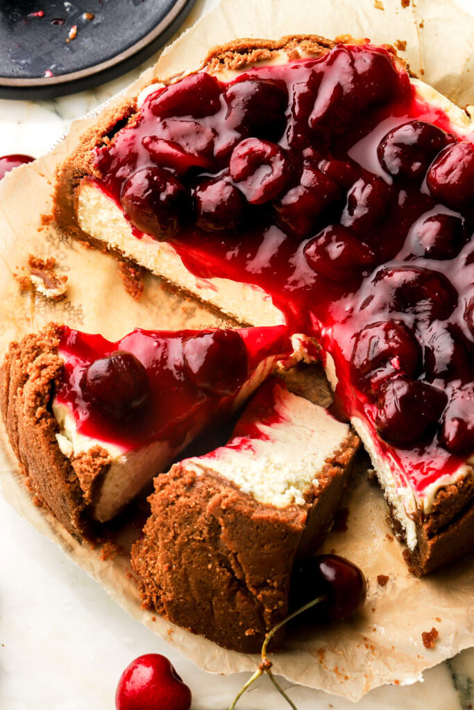 cherry cheesecake with two slices cut out