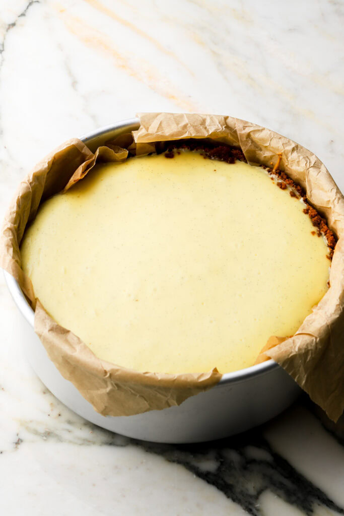 cheesecake finished baking (right out the oven, you can see it's slightly puffed but if you wiggle it it's still jiggly like jello)