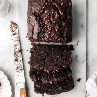 sliced chocolate banana bread with mini chocolate chips on top