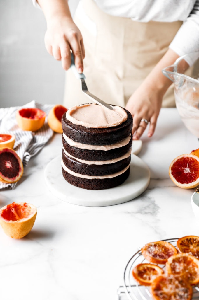 frosting dark chocolate cake with blood orange buttercream