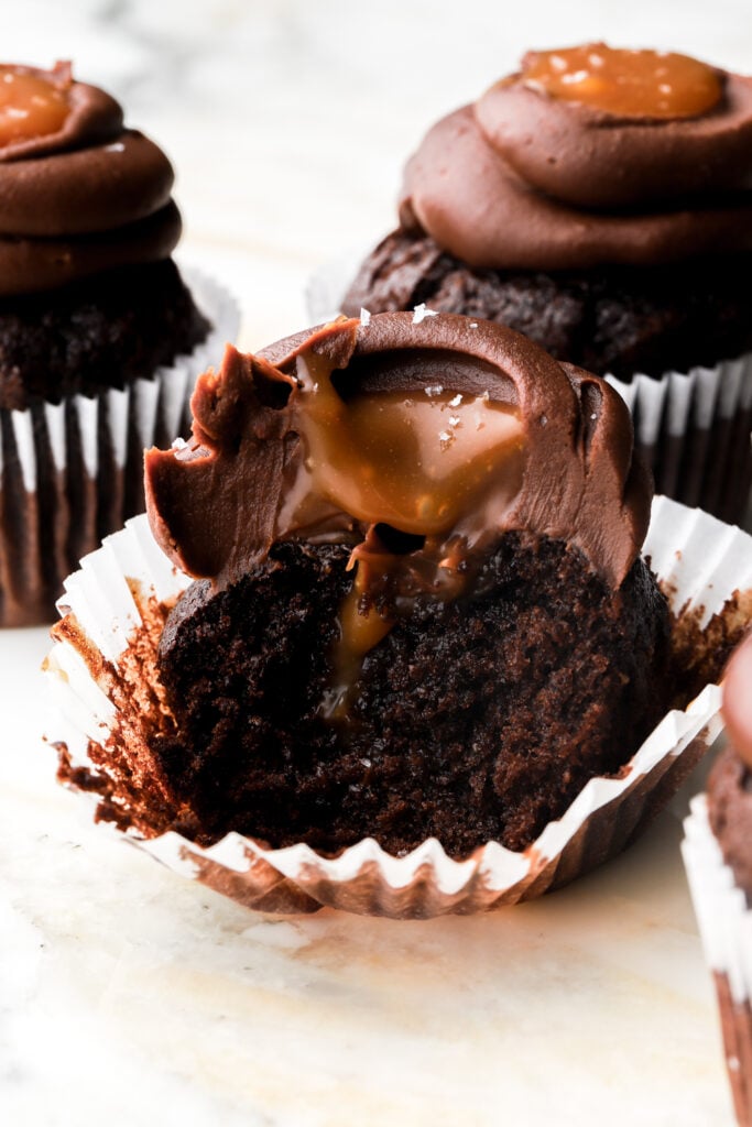 chocolate cupcakes filled with salted caramel sauce and topped with chocolate ganache