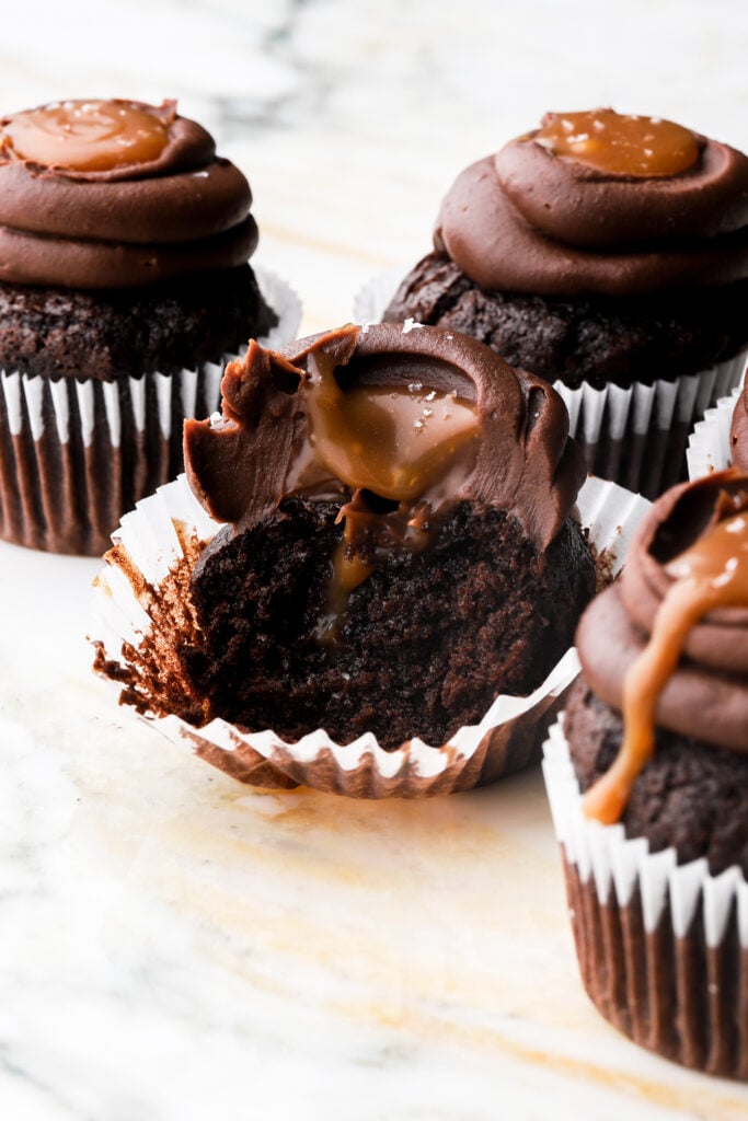 chocolate cupcakes filled with caramel sauce and frosted with chocolate ganache