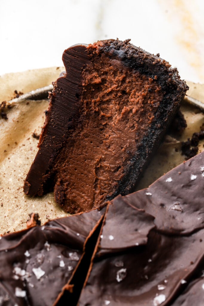 slice of chocolate cheesecake laying on it's side