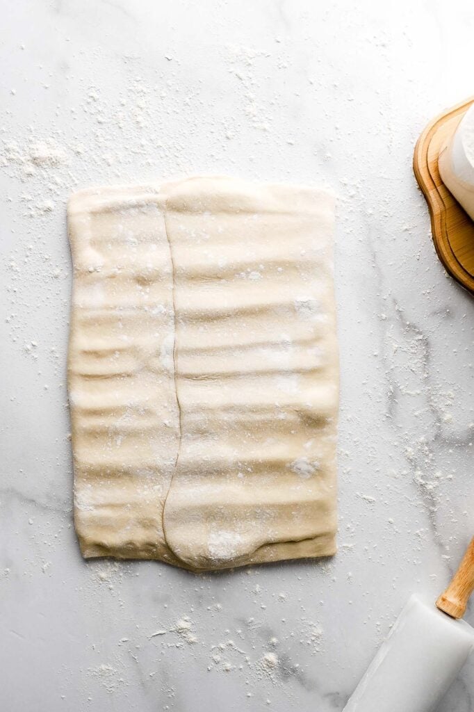 fold dough over butter and press/roll it to seal the butter in