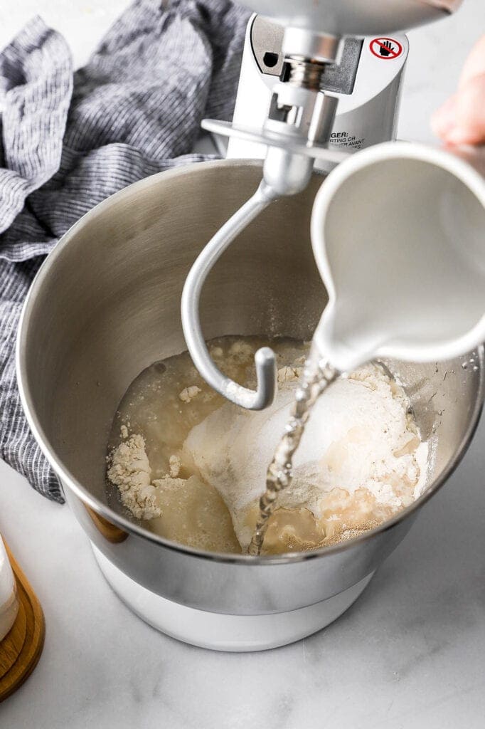 ingredients for dough being added to the bowl