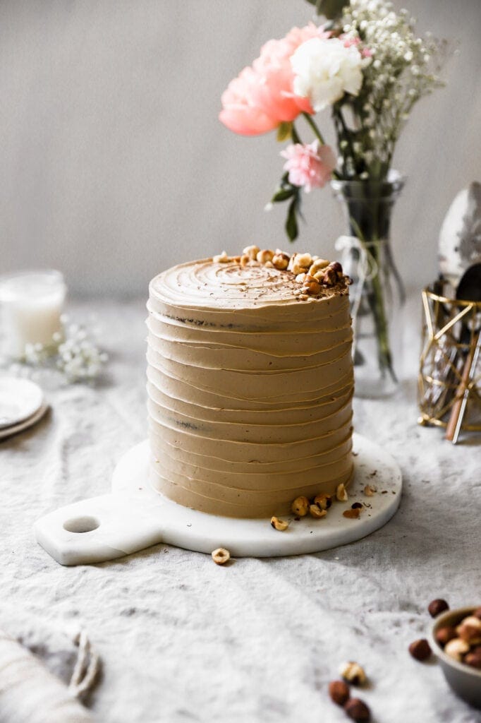 tall cake with toasted hazelnuts and chocolate shavings