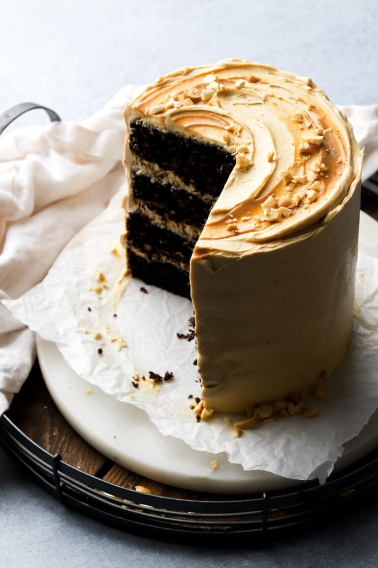 Chocolate peanut butter cake, cut into, sitting on marble board on a wooden tray