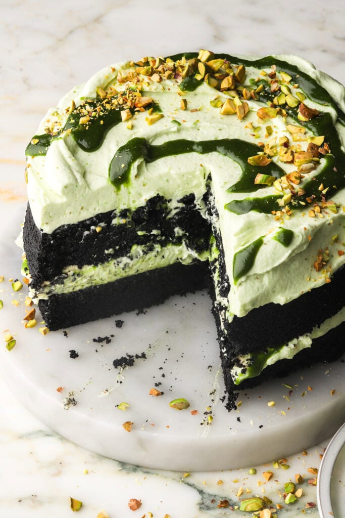 slice of chocolate pistachio cake taken out of cake