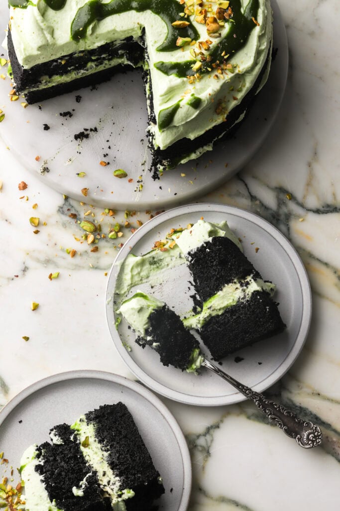 chocolate pistachio cake with slices on a plate