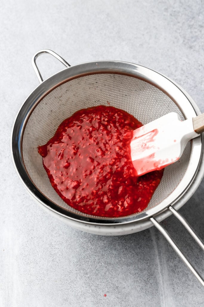 raspberry cake filling straining the seeds out