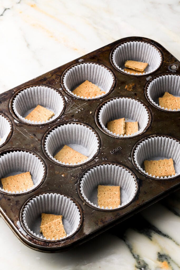 graham crackers on the bottom of the cupcake liners