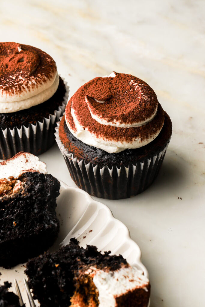 chocolate coffee cupcake frosted with mascarpone cream and dusted with cocoa powder