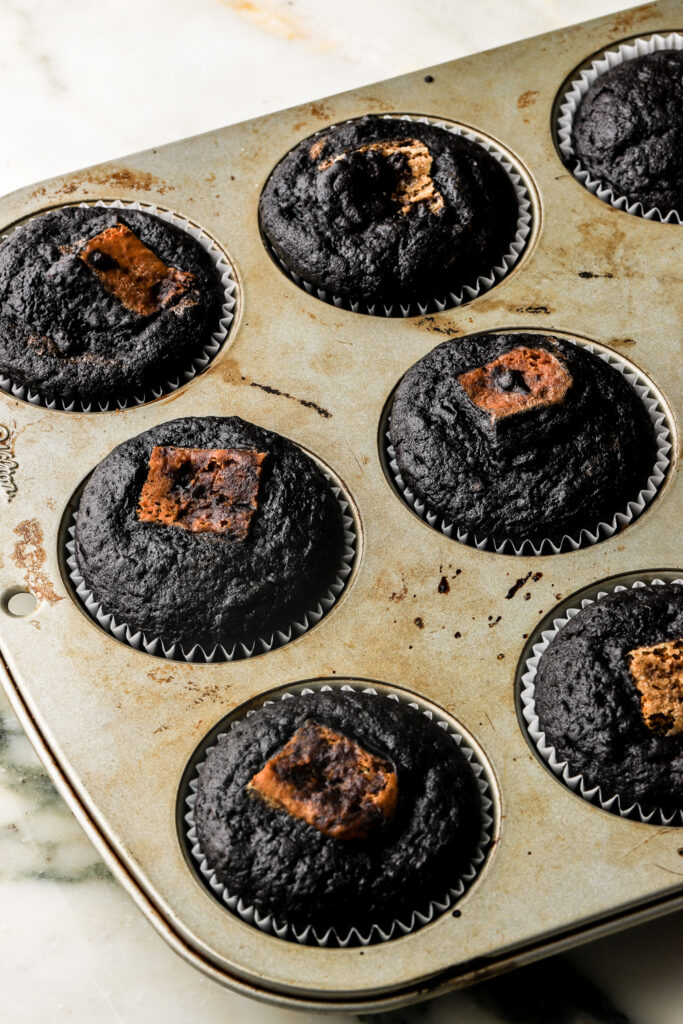 baked chocolate cupcake batter with espresso soaked lady finger in the middle