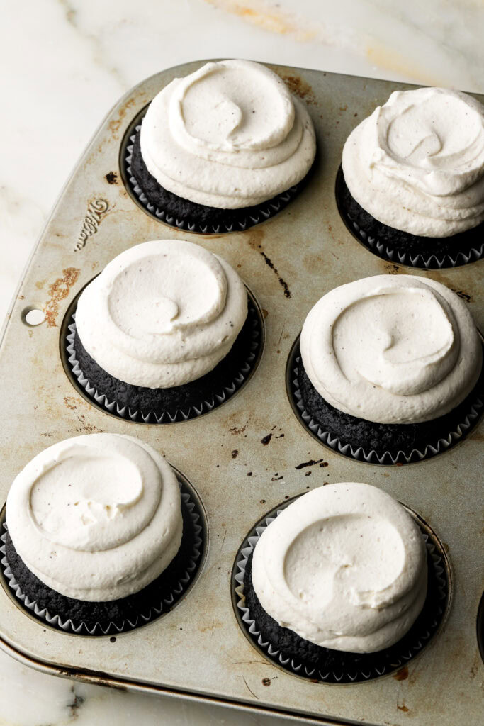 mascarpone cream piped onto chocolate cupcakes 