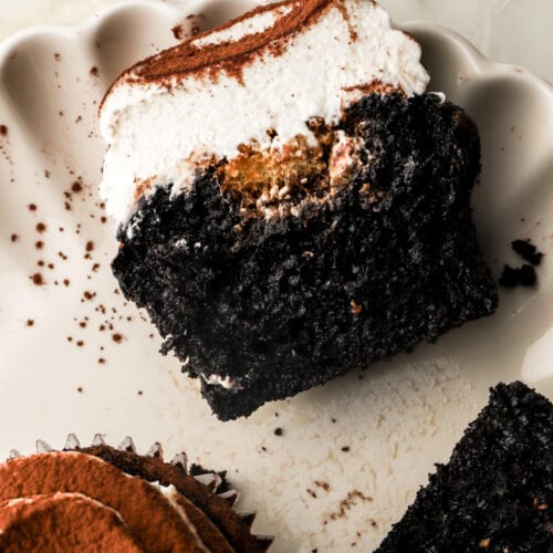 chocolate tiramisu cupcake sliced in half on a plate