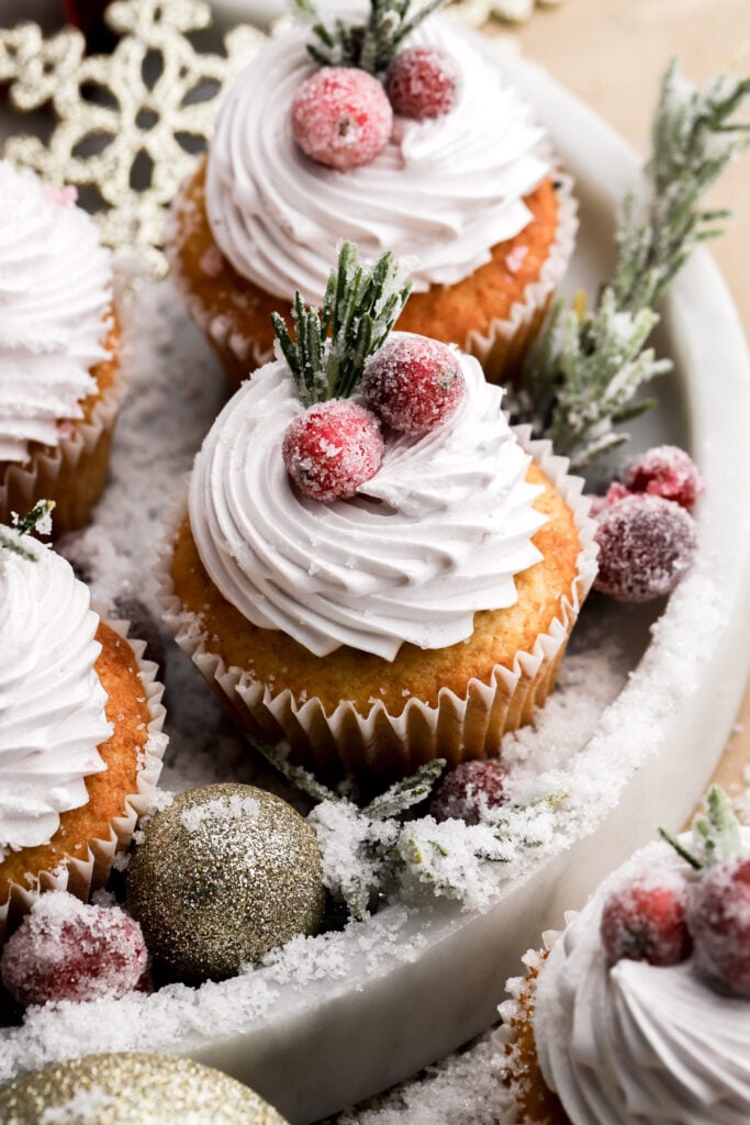 frosted cranberry cupcakes topped with sugared rosemary