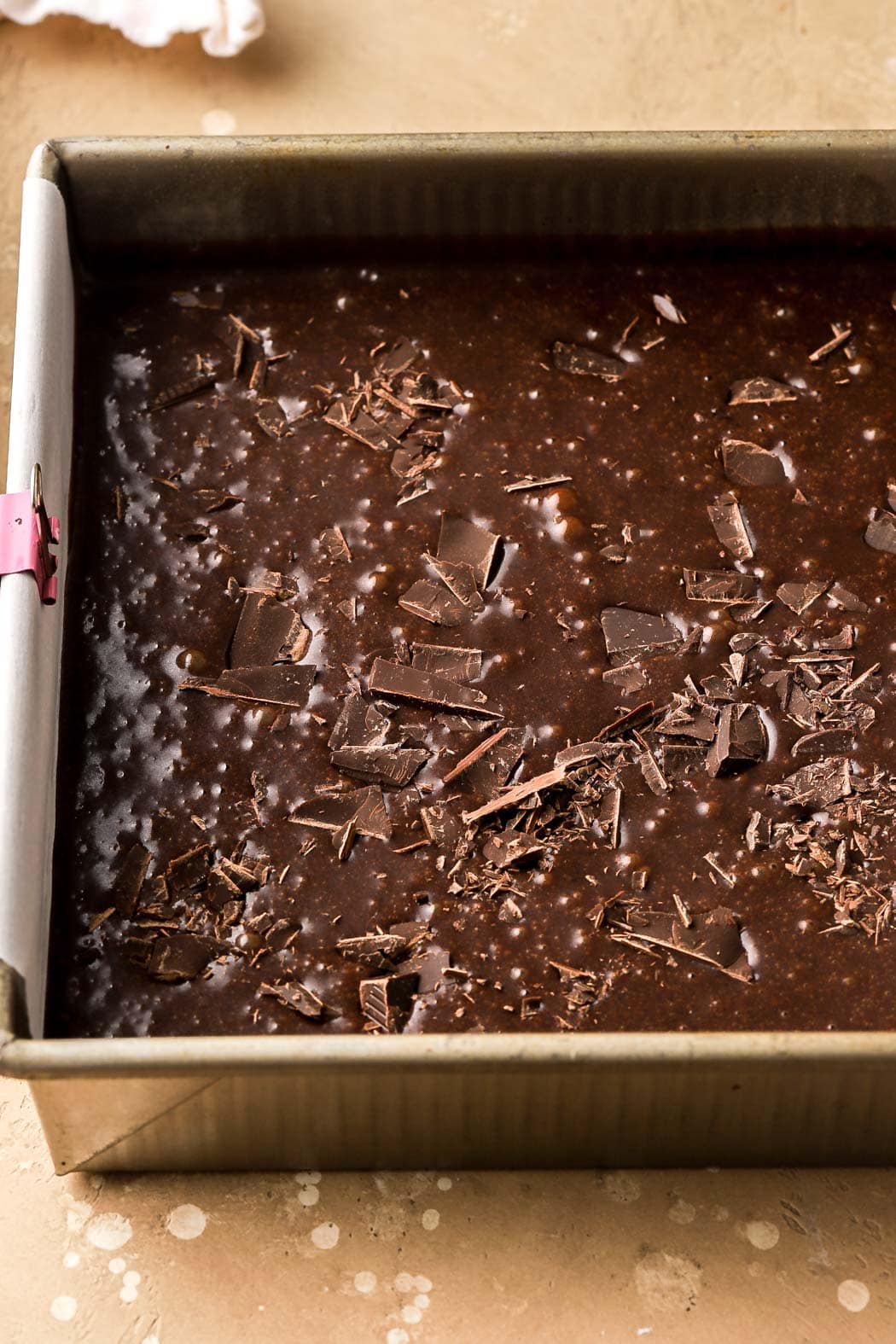brownie batter in lined pan