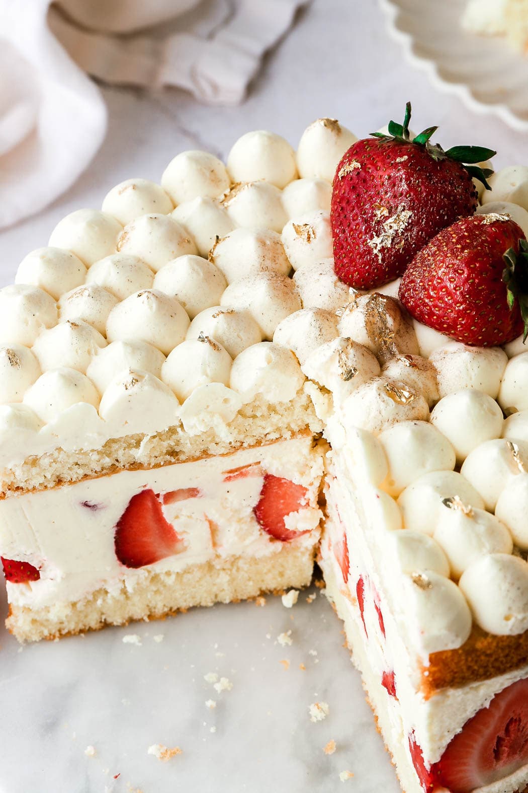 top with more strawberries and gold foil/gold flakes