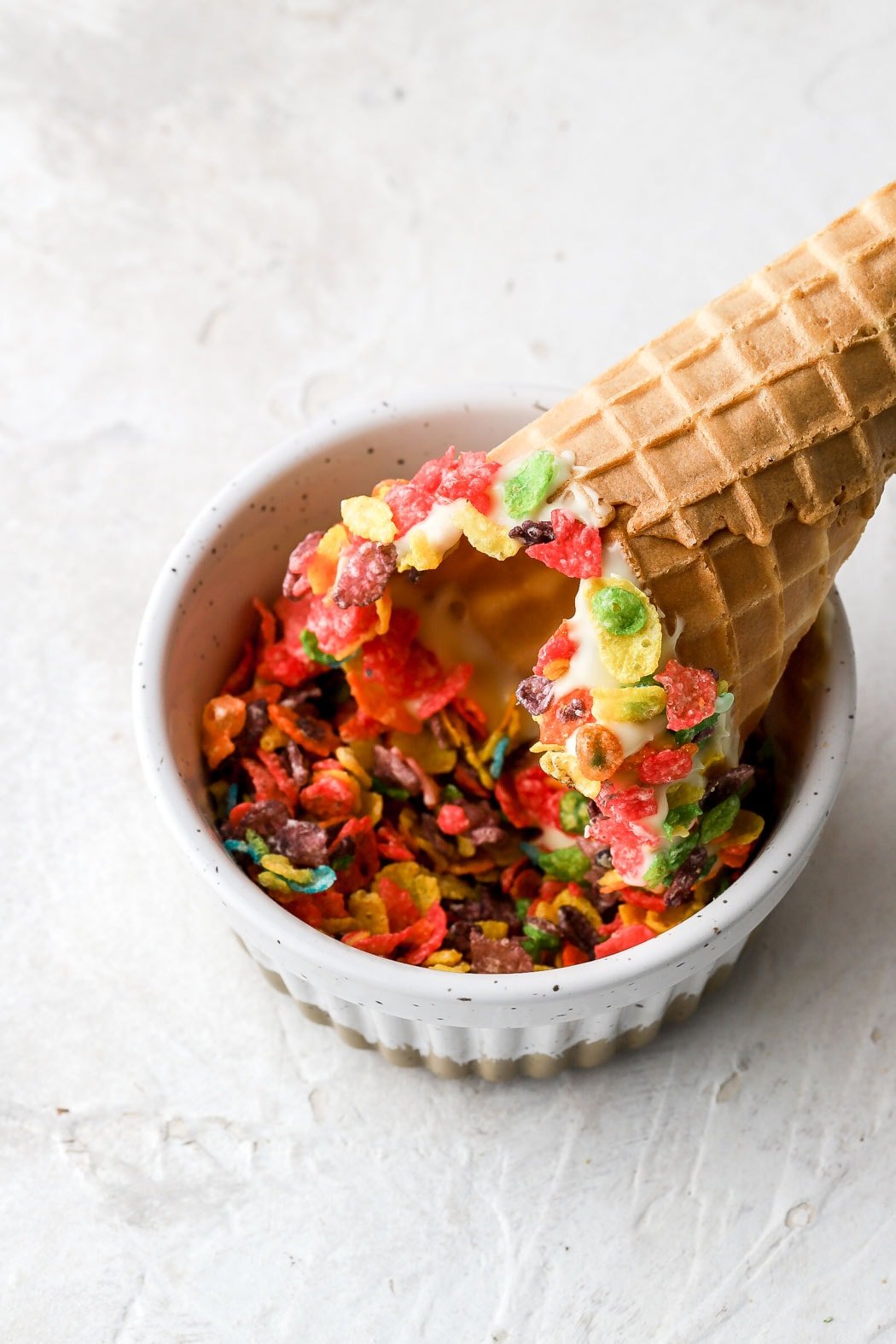 dip cone with melted chocolate in cereal