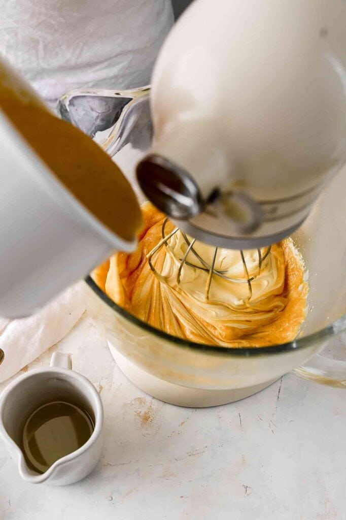 pour hot honey over eggs and sugar while beating