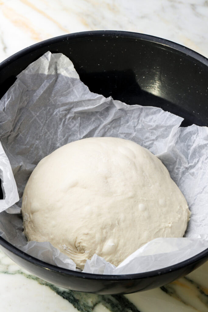 dough ball proofing in a bowl